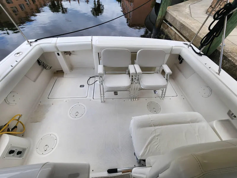 Slide: The Image of 2001 Tiara Yachts 3100 Open boat deck with white seating and clean layout. - 11