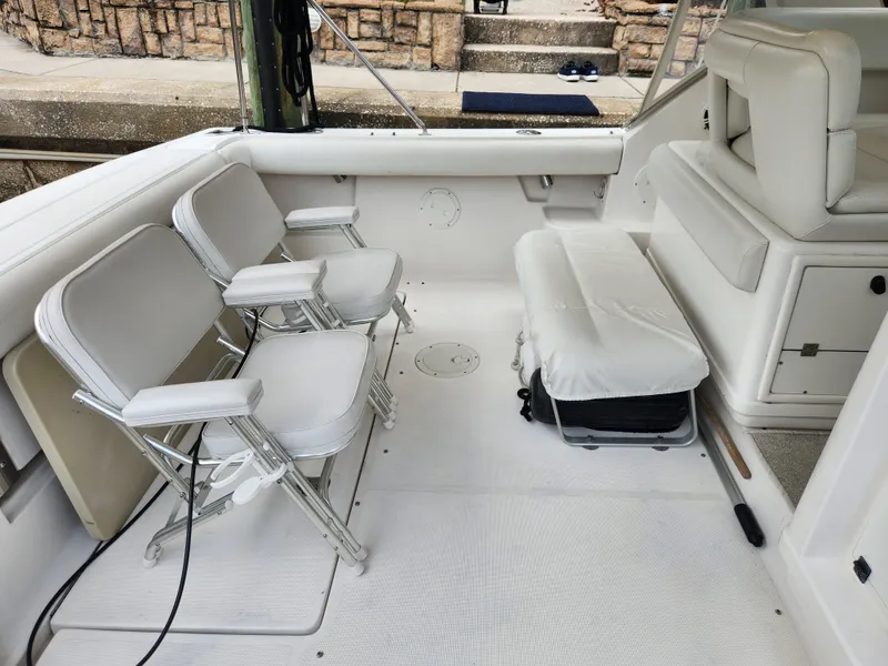 Slide: The Image of 2001 Tiara Yachts 3100 Open interior with white seating and deck chairs. - 12