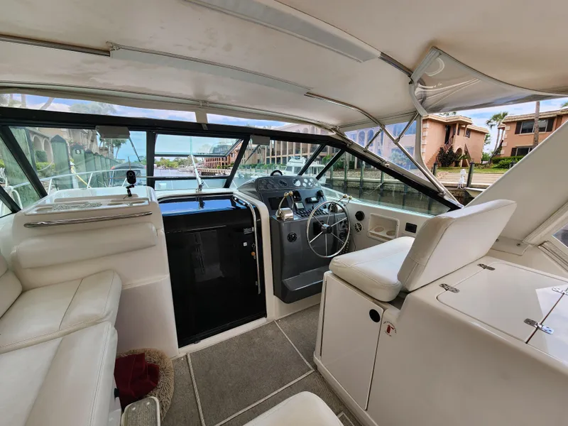 Slide: The Image of 2001 Tiara Yachts 3100 Open interior with helm, seating, and panoramic windows. - 16