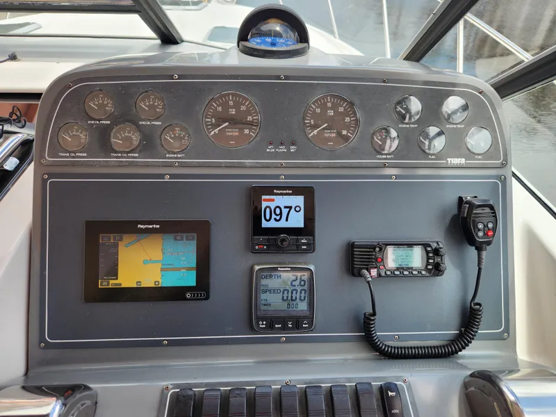 Slide: The Image of Dashboard of a 2001 Tiara Yachts 3100 Open with navigation and communication instruments. - 17