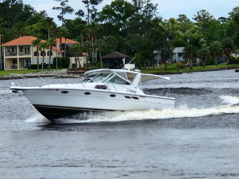 Slide: The Image of 2001 Tiara Yachts 3100 Open cruising on a scenic river. - 2