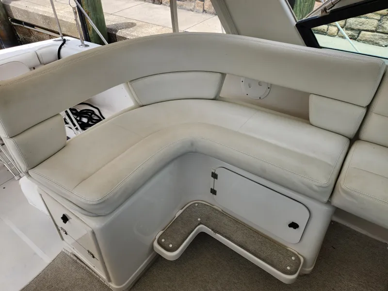 Slide: The Image of 2001 Tiara Yachts 3100 Open interior with white cushioned seating and storage compartments. - 22
