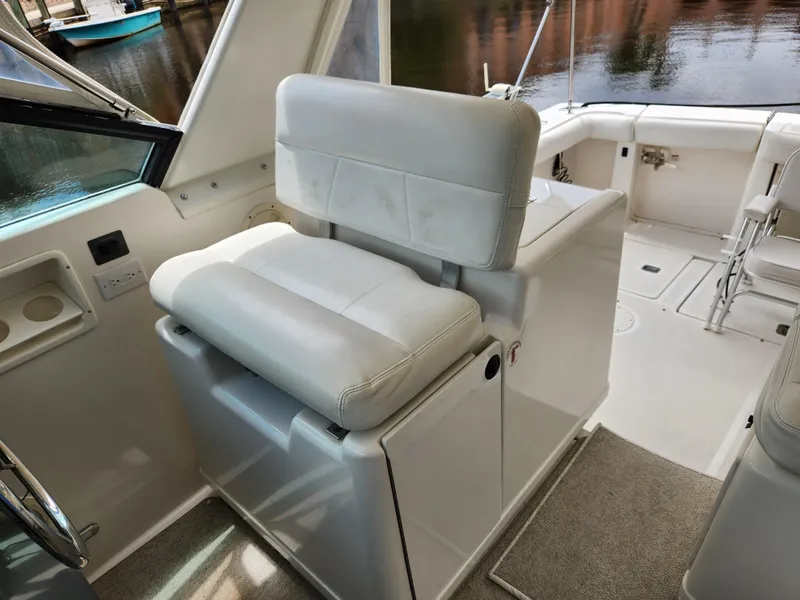 Slide: The Image of 2001 Tiara Yachts 3100 Open interior with white seating and helm area. - 23