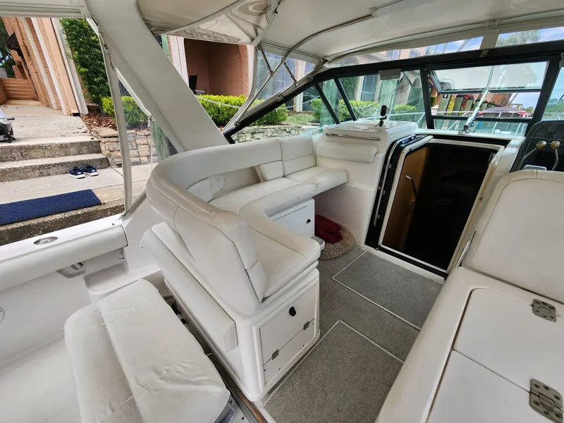 Slide: The Image of 2001 Tiara Yachts 3100 Open interior with white seating and helm, showcasing luxury design. - 24