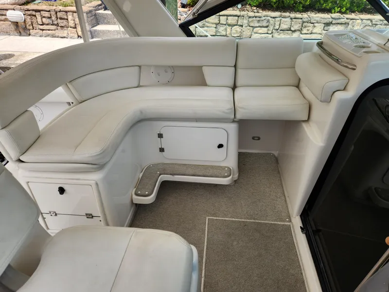 Slide: The Image of 2001 Tiara Yachts 3100 Open interior with white seating and carpeted flooring. - 25