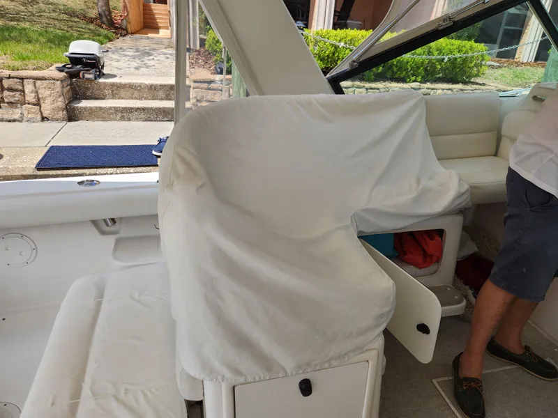 Slide: The Image of 2001 Tiara Yachts 3100 Open interior with covered seating and visible storage. - 27