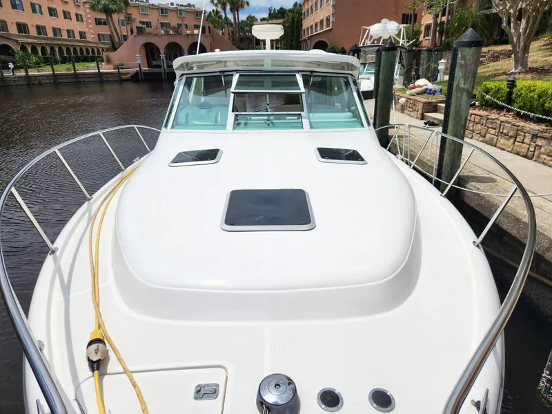 Slide: The Image of 2001 Tiara Yachts 3100 Open docked, showcasing sleek design and spacious deck. - 30