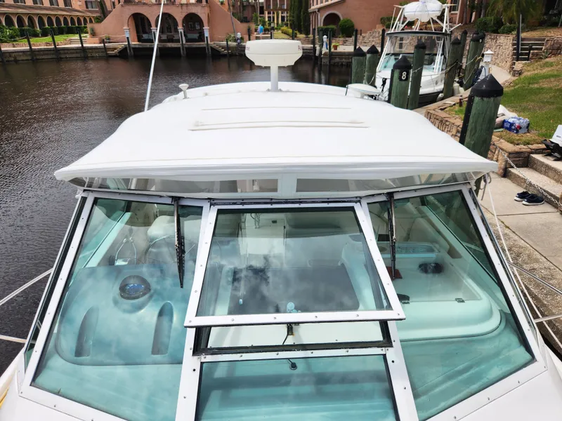 Slide: The Image of 2001 Tiara Yachts 3100 Open boat docked at marina, viewed from the front. - 31