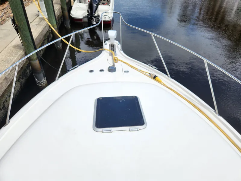 Slide: The Image of 2001 Tiara Yachts 3100 Open boat deck with railing and docked at marina. - 33