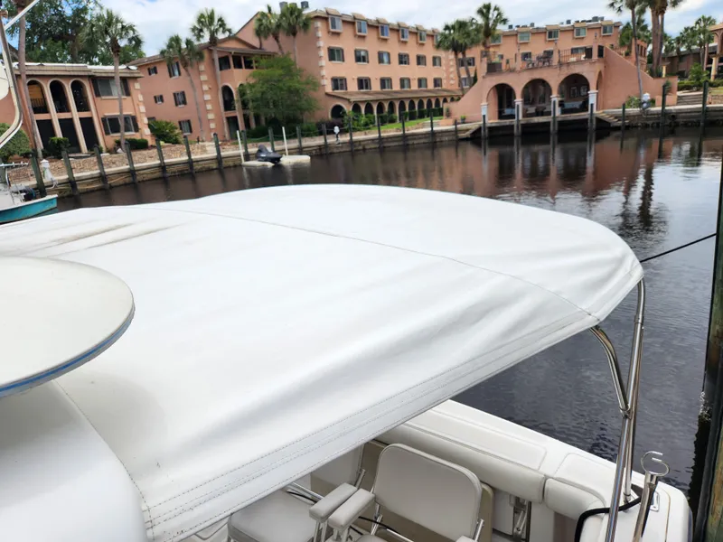 Slide: The Image of 2001 Tiara Yachts 3100 Open docked near waterfront buildings. - 35