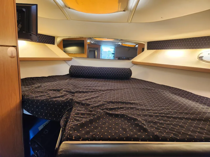 Slide: The Image of 2001 Tiara Yachts 3100 Open cabin interior with cozy bed and modern amenities. - 46