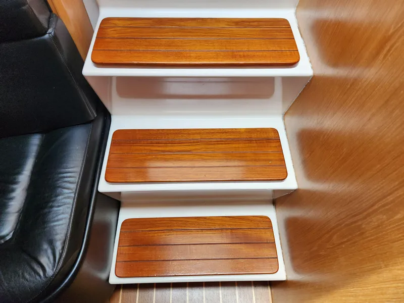 Slide: The Image of Wooden steps inside a 2001 Tiara Yachts 3100 Open, showcasing elegant interior design. - 49