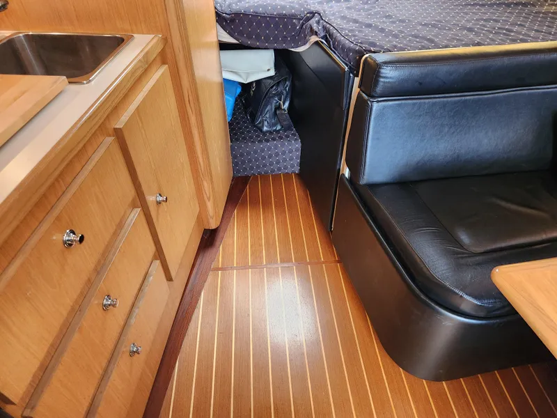 Slide: The Image of 2001 Tiara Yachts 3100 Open interior with wood cabinetry and black seating. - 50