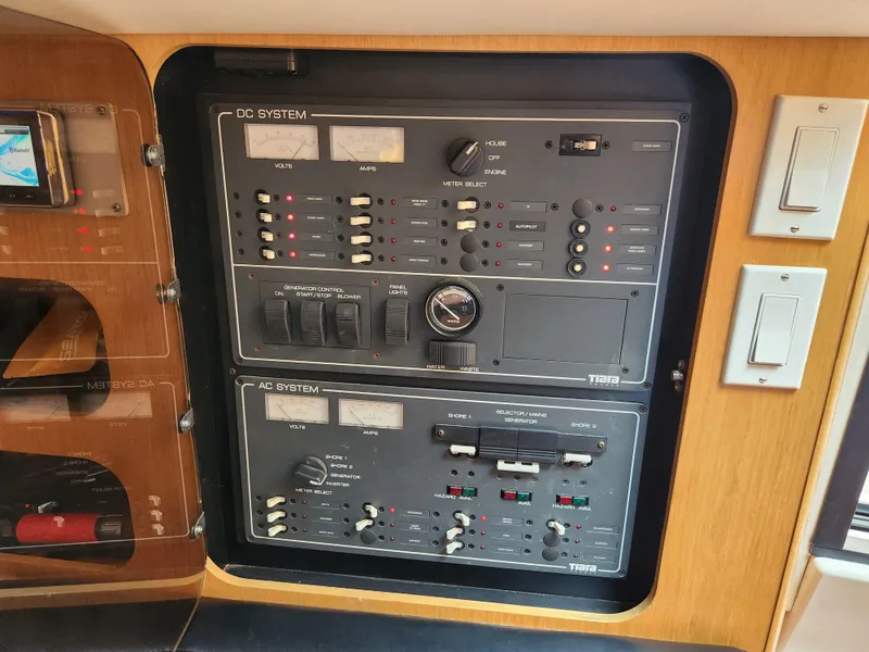 Slide: The Image of Electrical control panel on a 2001 Tiara Yachts 3100 Open boat, featuring DC and AC systems. - 51