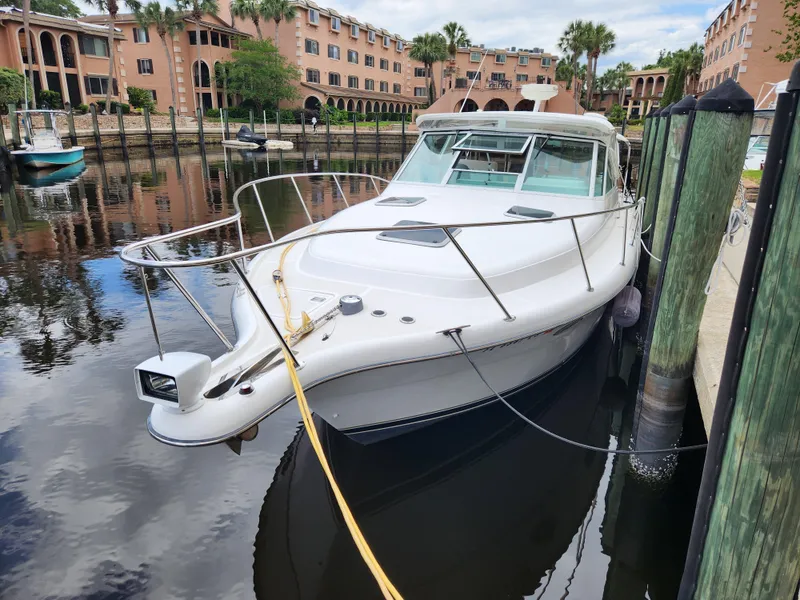 Slide: The Image of 2001 Tiara Yachts 3100 Open docked in a marina with waterfront buildings. - 7
