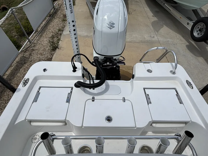 Slide: The Image of Blazer Bay 2020 boat stern with Suzuki outboard motor, rod holders, and storage compartments. - 15
