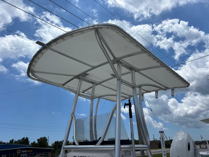 Slide: The Image of T-top canopy of a 2023 Blazer Bay 2020 boat against a cloudy sky. - 26