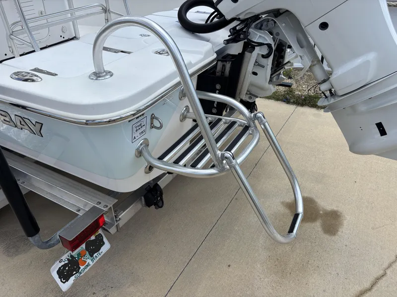 Slide: The Image of Blazer Bay 2020 boat with ladder and motor, 2023 model, on a concrete surface. - 31