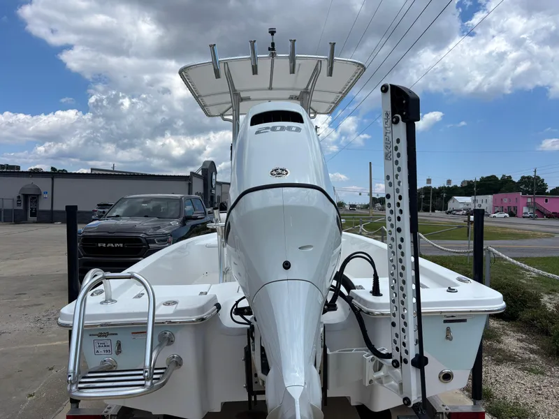 Slide: The Image of Blazer Bay 2020 boat, rear view, parked outdoors, showcasing motor and ladder, 2023 model. - 34