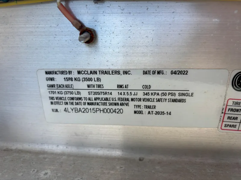 Slide: The Image of McClain Trailers label with specifications, including GVM and manufacturing date, April 2022. - 36