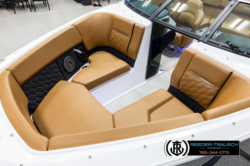 Slide: The Image of 2023 Four Winns H2 boat interior with tan leather seating and hexagonal pattern accents. - 10