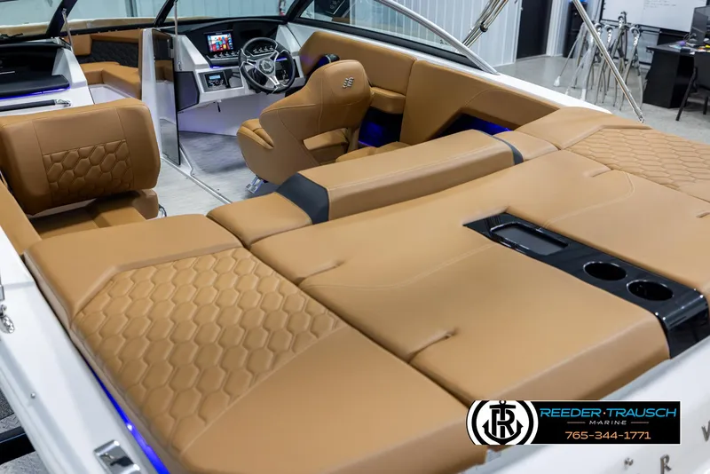 Slide: The Image of 2023 Four Winns H2 boat interior with tan leather seating and modern dashboard. - 11
