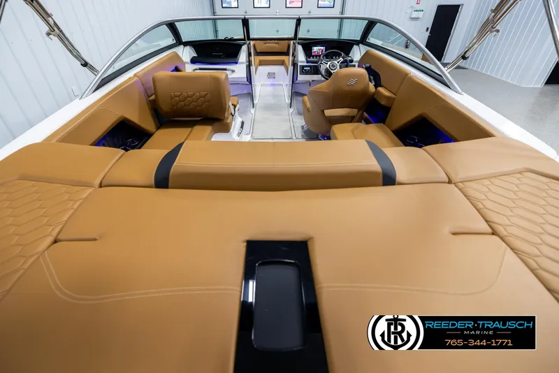 Slide: The Image of 2023 Four Winns H2 boat interior with tan leather seating and modern dashboard. - 13