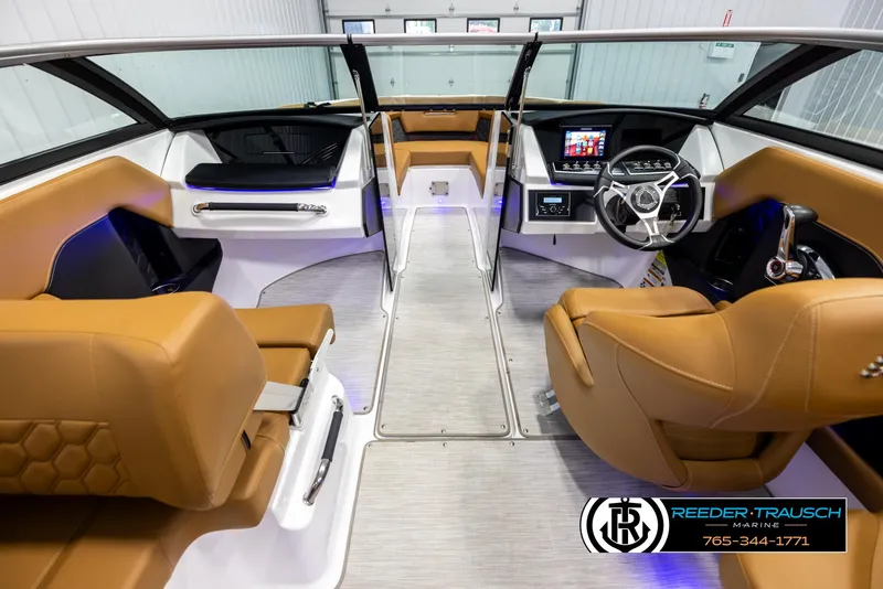 Slide: The Image of 2023 Four Winns H2 boat interior with tan seating and modern dashboard. - 14