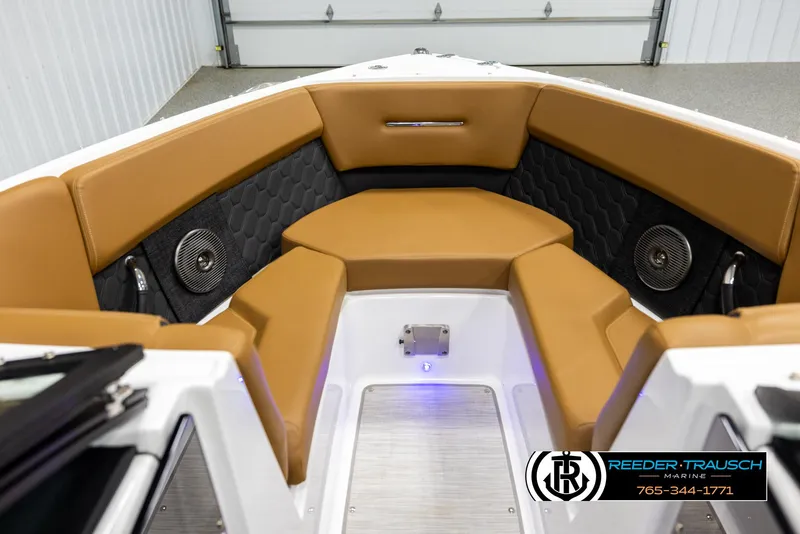Slide: The Image of 2023 Four Winns H2 boat interior with tan seating and black accents. - 15