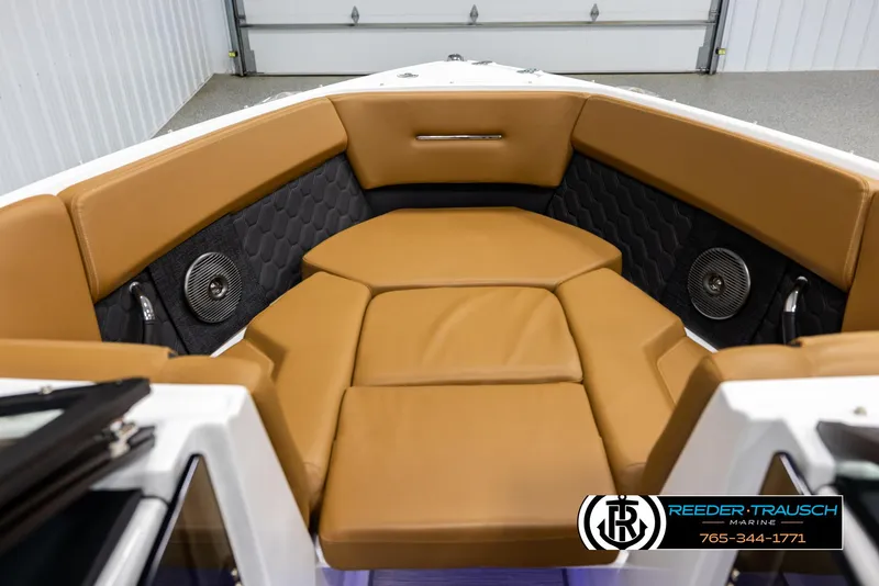 Slide: The Image of 2023 Four Winns H2 boat interior with tan seating and black accents. - 16