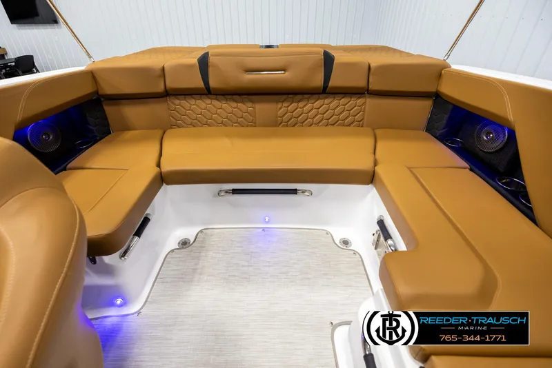 Slide: The Image of Luxurious tan seating in 2023 Four Winns H2 boat interior with blue LED lighting. - 20