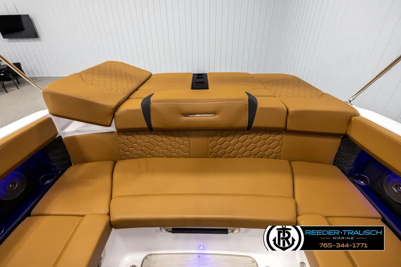 Slide: The Image of 2023 Four Winns H2 boat interior with tan leather seating and modern design. - 23