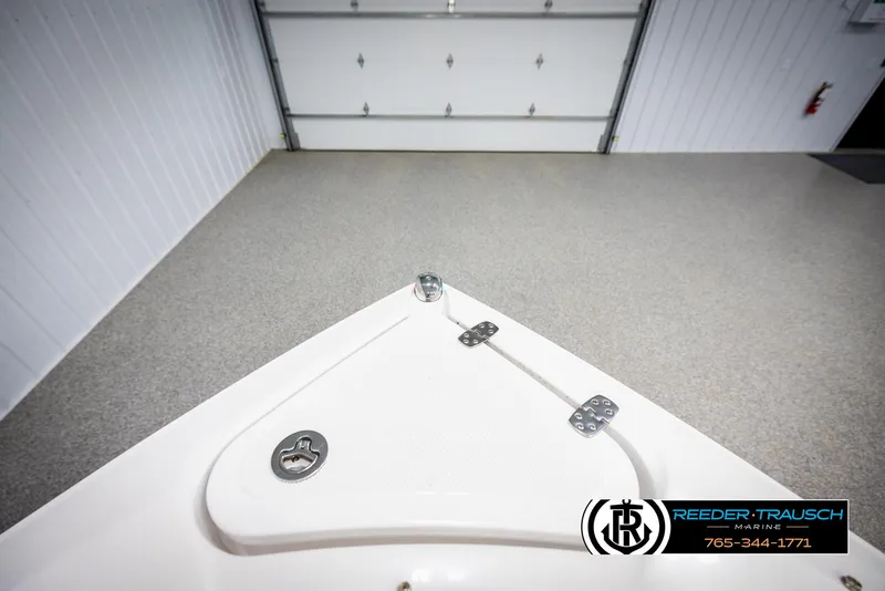 Slide: The Image of 2023 Four Winns H2 boat bow in a garage, featuring a sleek design. - 27