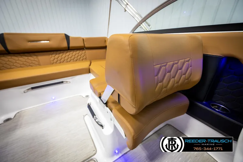 Slide: The Image of 2023 Four Winns H2 boat interior with tan leather seating and modern design. - 30