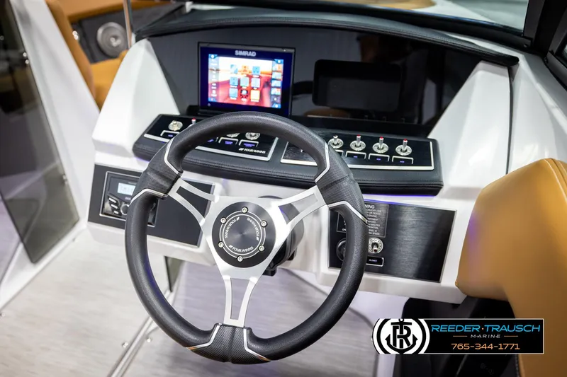 Slide: The Image of 2023 Four Winns H2 boat dashboard with steering wheel and control panel. - 31