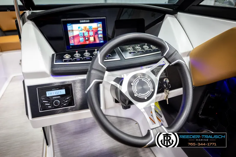 Slide: The Image of 2023 Four Winns H2 boat dashboard with steering wheel and digital display. - 32