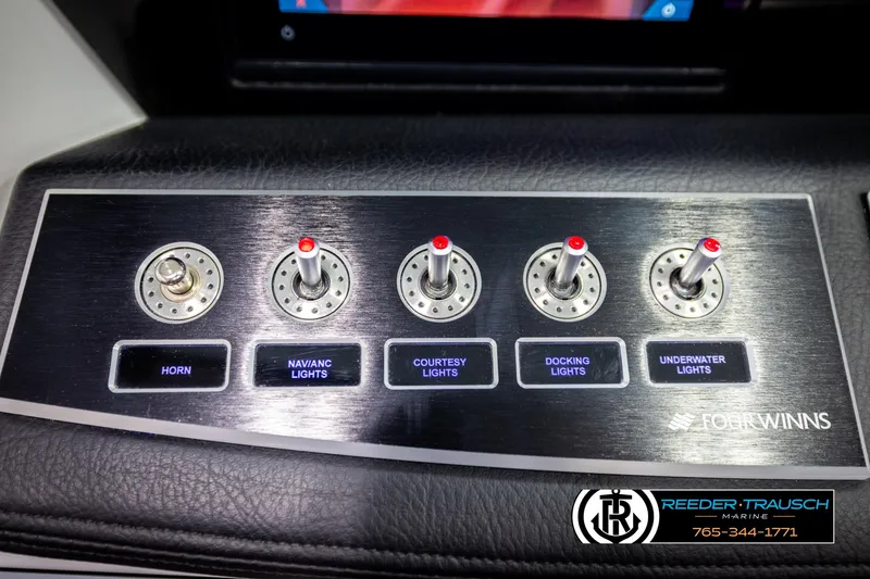 Slide: The Image of 2023 Four Winns H2 control panel with switches for horn and various lights. - 35