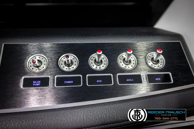 Slide: The Image of 2023 Four Winns H2 boat control panel with switches for bilge pump, tower, and accessories. - 37