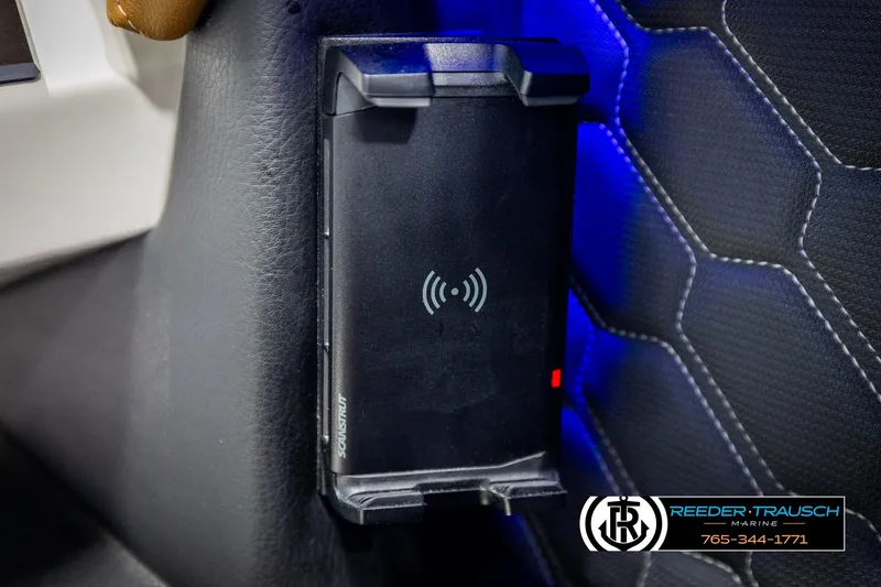 Slide: The Image of 2023 Four Winns H2 wireless charging station with blue ambient lighting. - 38