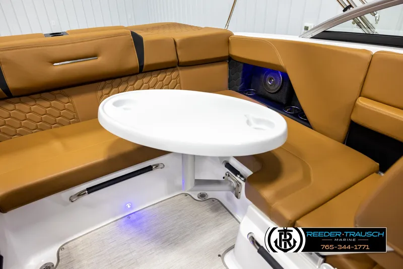 Slide: The Image of 2023 Four Winns H2 boat interior with tan seating and white table. - 41