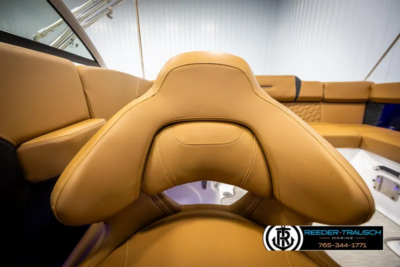 Slide: The Image of 2023 Four Winns H2 boat interior with tan leather seating, showcasing luxury and comfort. - 42