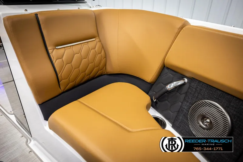 Slide: The Image of 2023 Four Winns H2 boat interior with tan leather seating and speaker detail. - 43