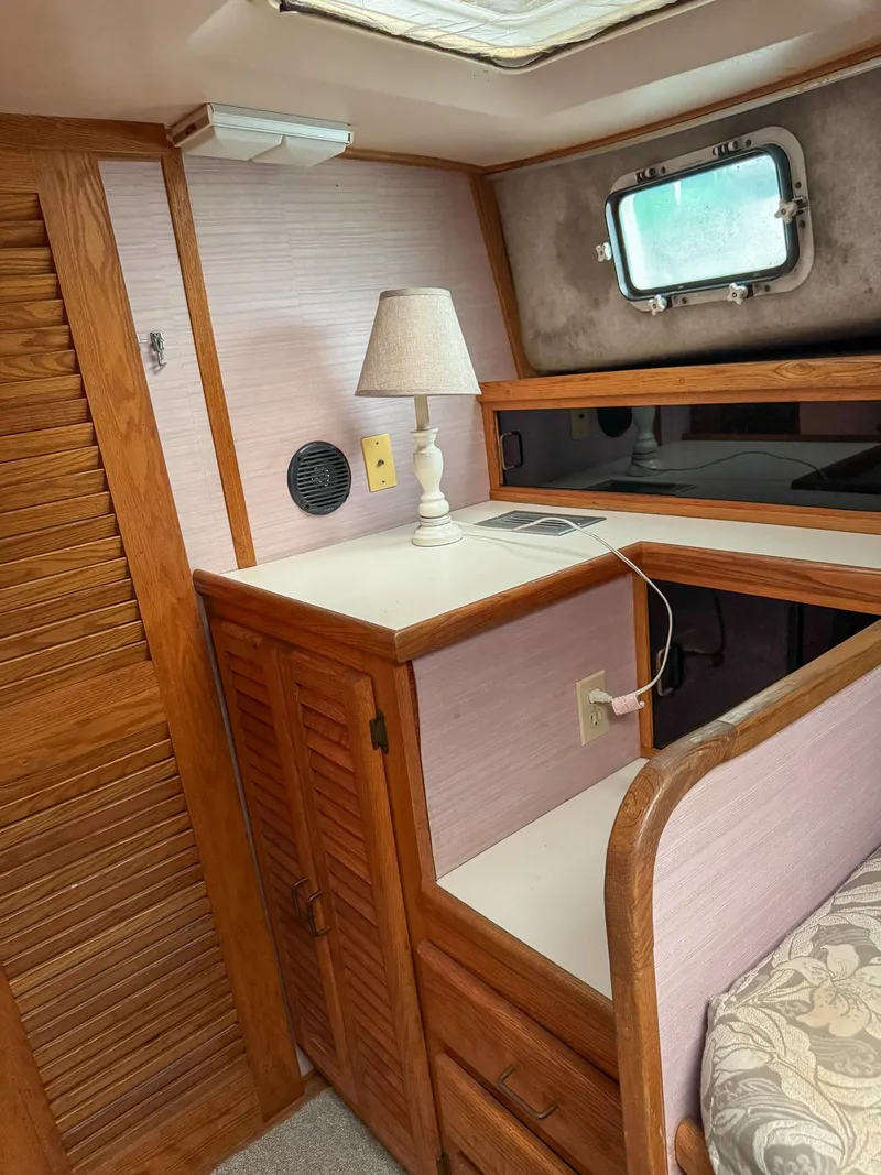 Slide: The Image of 1987 Mainship 40 Aft Cabin interior with wood cabinetry and lamp. - 19