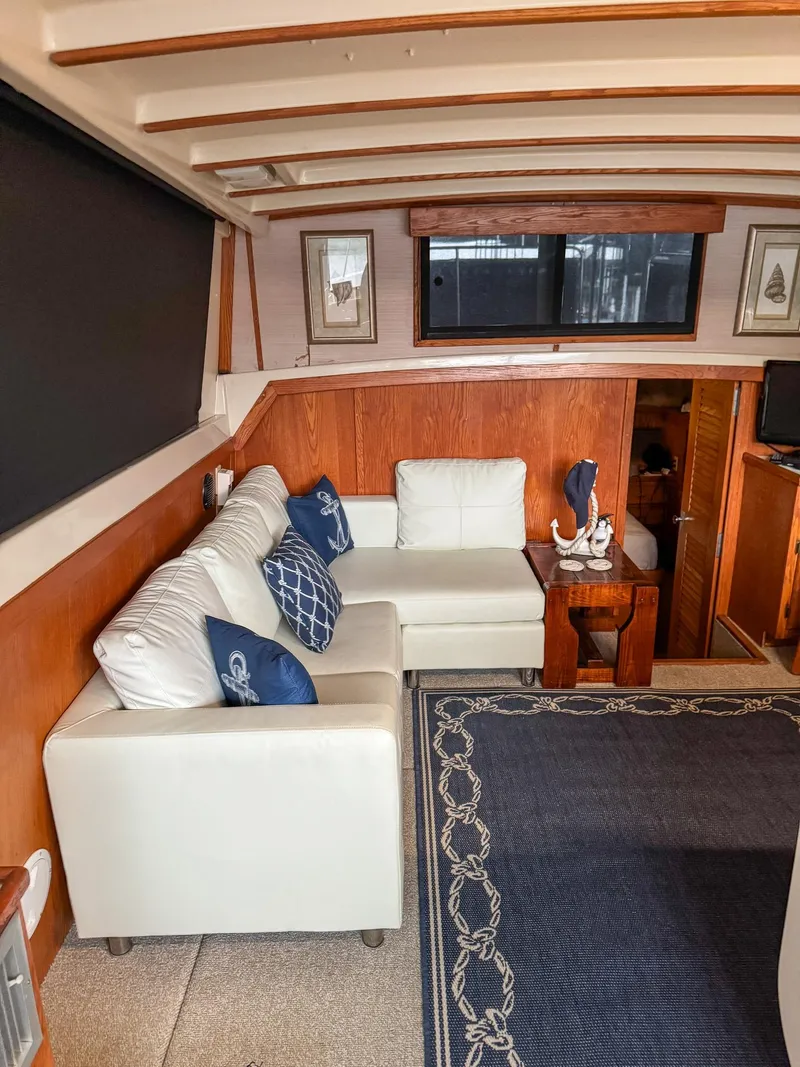 Slide: The Image of Interior of 1987 Mainship 40 Aft Cabin with white sofa and nautical decor. - 25