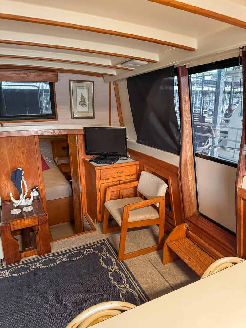 Slide: The Image of 1987 Mainship 40 Aft Cabin interior with wood furnishings and nautical decor. - 28