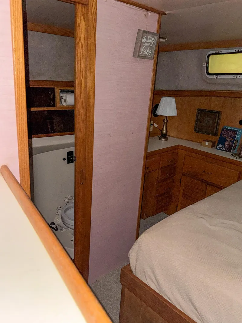 Slide: The Image of 1987 Mainship 40 Aft Cabin interior with bed, lamp, and bathroom. - 37