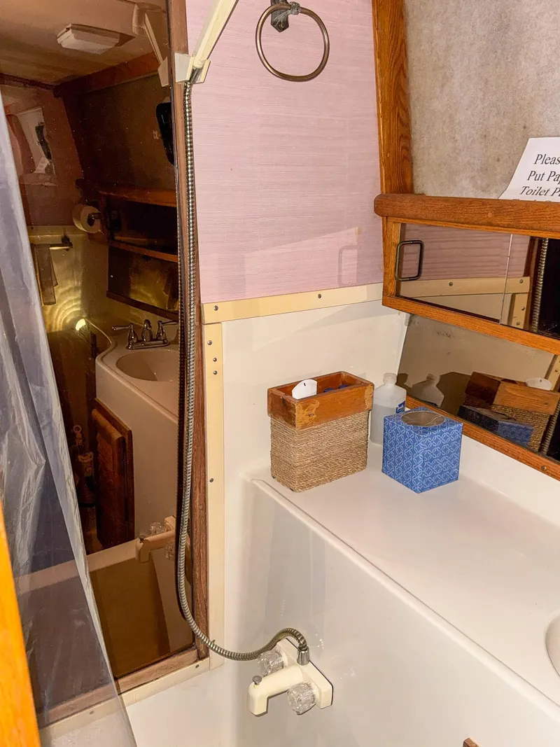 Slide: The Image of 1987 Mainship 40 Aft Cabin bathroom with shower, sink, and mirror. - 39