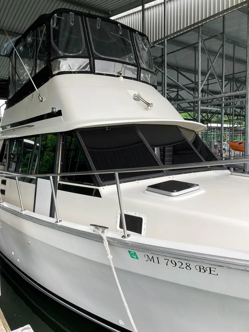 Slide: The Image of 1987 Mainship 40 Aft Cabin yacht docked in a covered marina. - 4