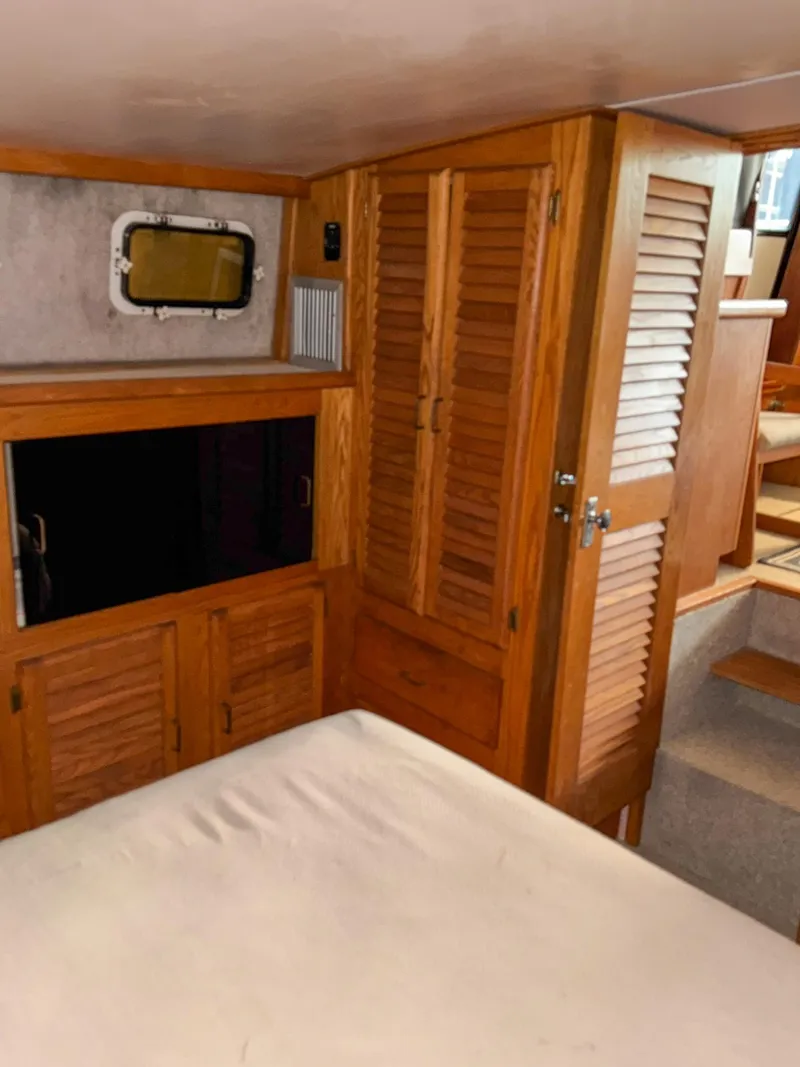 Slide: The Image of 1987 Mainship 40 Aft Cabin interior with wooden cabinets and stairs. - 41