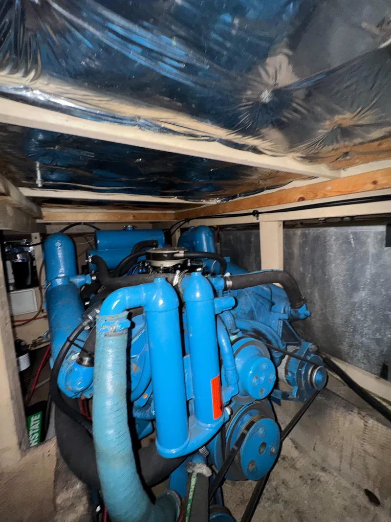 Slide: The Image of Engine room of 1987 Mainship 40 Aft Cabin with blue machinery and pipes. - 44